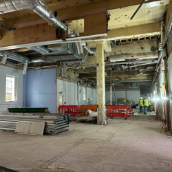 Image showing a building with builders inside and lots of demolition work of a nearly empty building.
