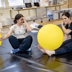 Two female dancers with large yellow balloons