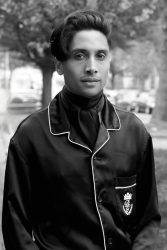 A black and white headshot of an Asian man looking at the camera