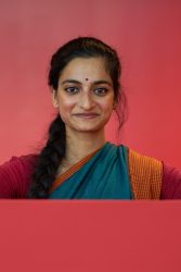 A headshot of an Indian woman looking at the camera