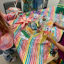 A photo of young people making paper flowers for a festival