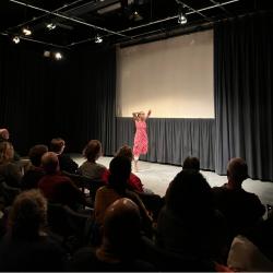 A photo of a woman in a red dress dancing