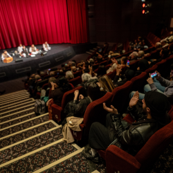 A photo of an audience watching a band on stage