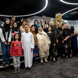 A large group of people all smiling at the camera