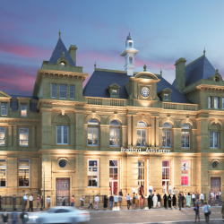 A photo of a large sandstone building with lots of people in front of it